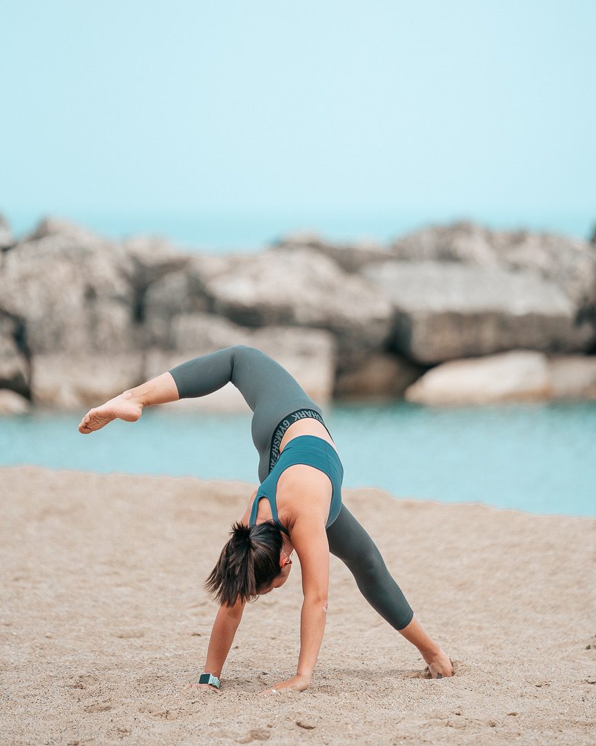 Coach Lauren Scholl stretching on the beach